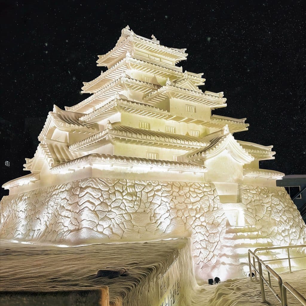 Massive illuminated snow sculpture at Sapporo Snow Festival, a highlight of our Hokkaido Winter Adventure.